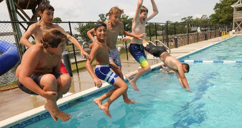 Campers jumping into pool at Camp Sea Gull