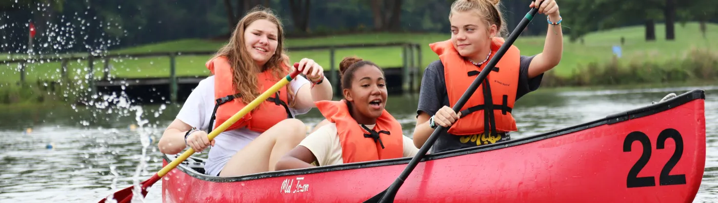 Three girls in a canoe at Day Camp