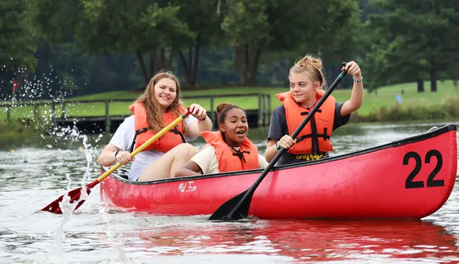 Three girls in a canoe at Day Camp