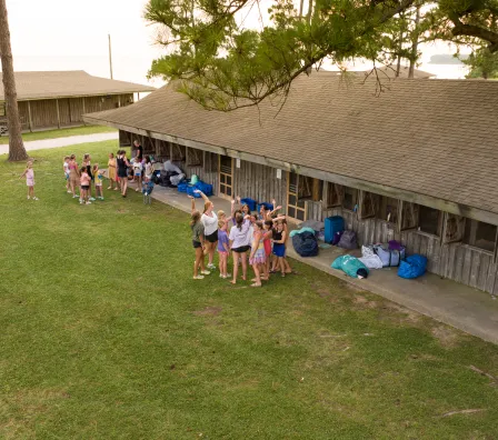Aerial view of girls outside cabins