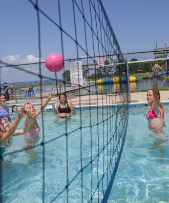 Girls playing water volleyball