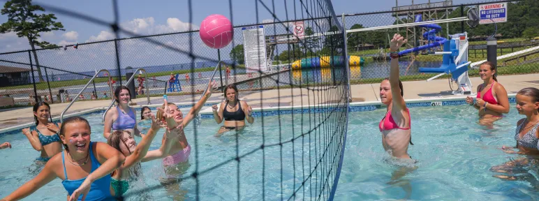 Girls playing water volleyball