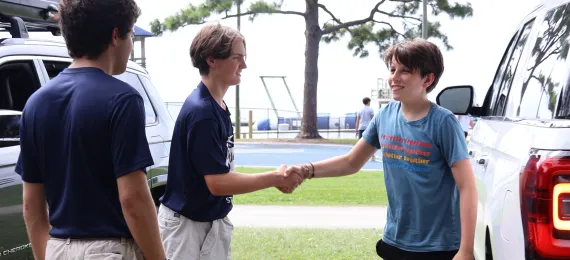 Counselor and volunteer with camper on Opening Day.