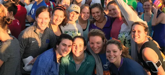 Group of alumni posing for a photo after the Run A Kid To Camp finish