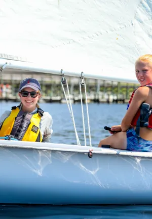 Two girls on a white sailboat