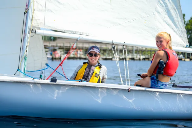 Two girls on a white sailboat