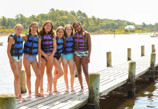 Six girls standing on the pier