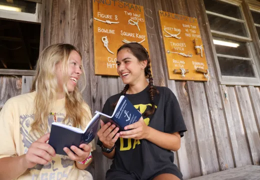 Two girls reviewing the blue books